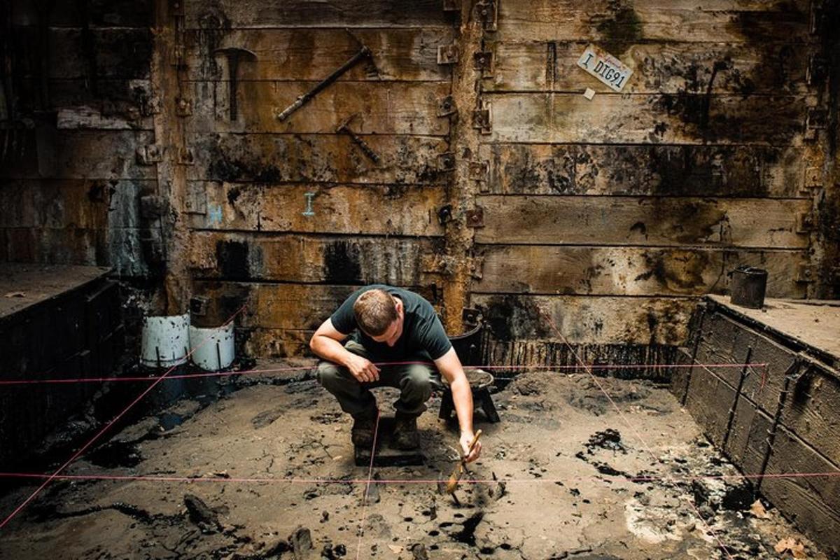 a man in a dirty room working on a toilet