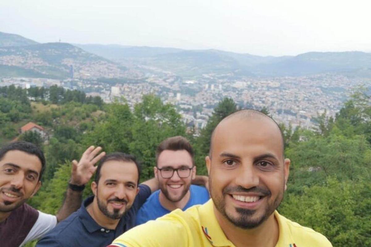 a group of men standing on top of a hill