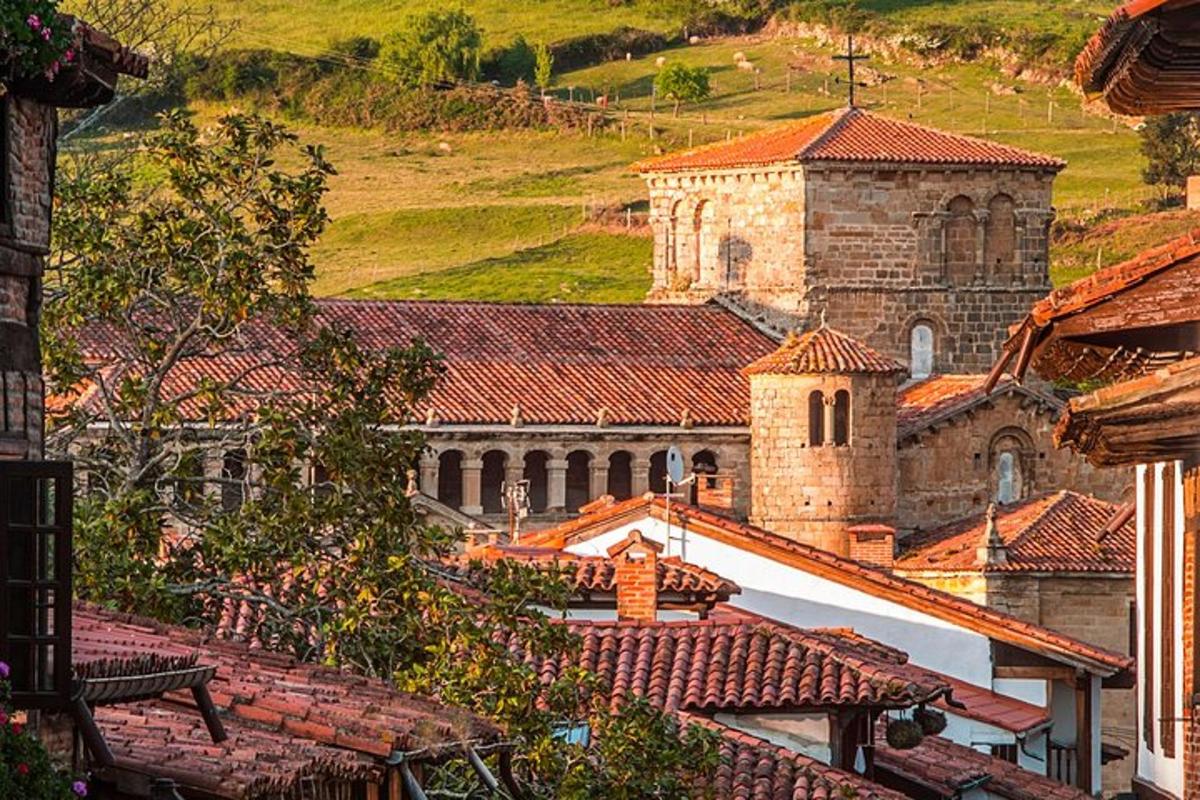 a group of buildings with roofs and a church