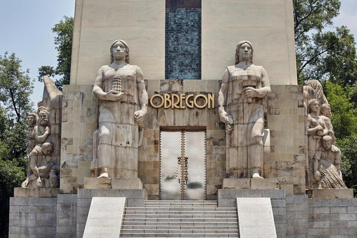 a monument with three statues in front of a building