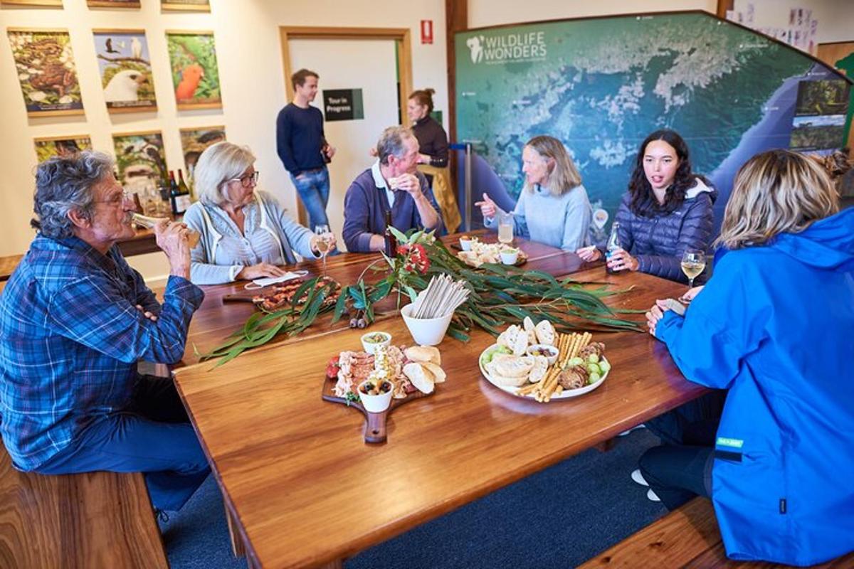 a group of people sitting around a table with food