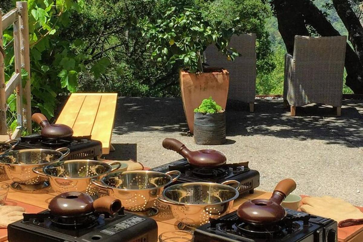 ένα τραπέζι με κατσαρόλες και τηγάνια πάνω σε εστίες μαγειρέματος