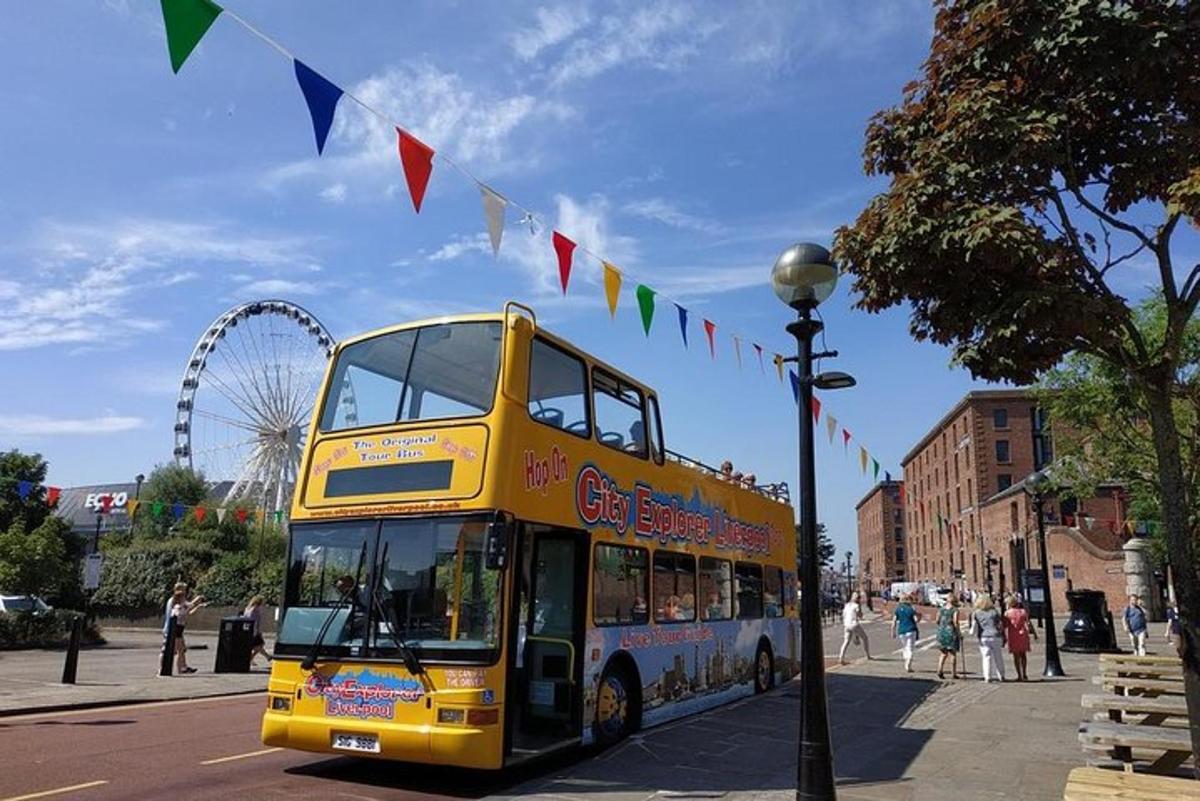 a yellow double decker bus driving down a street