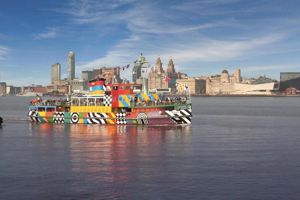 a colorful boat in the water near a city