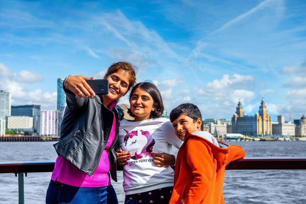 two women and a child taking a picture with a cell phone