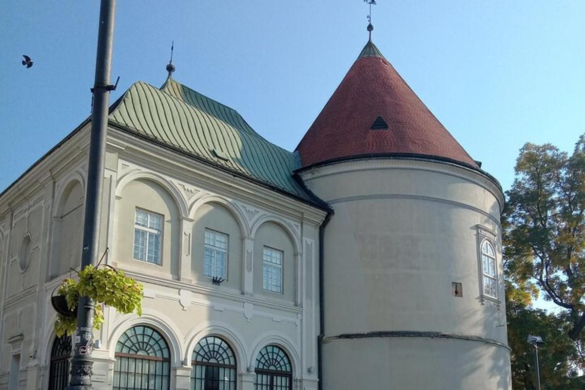 a building with a tower with a green roof