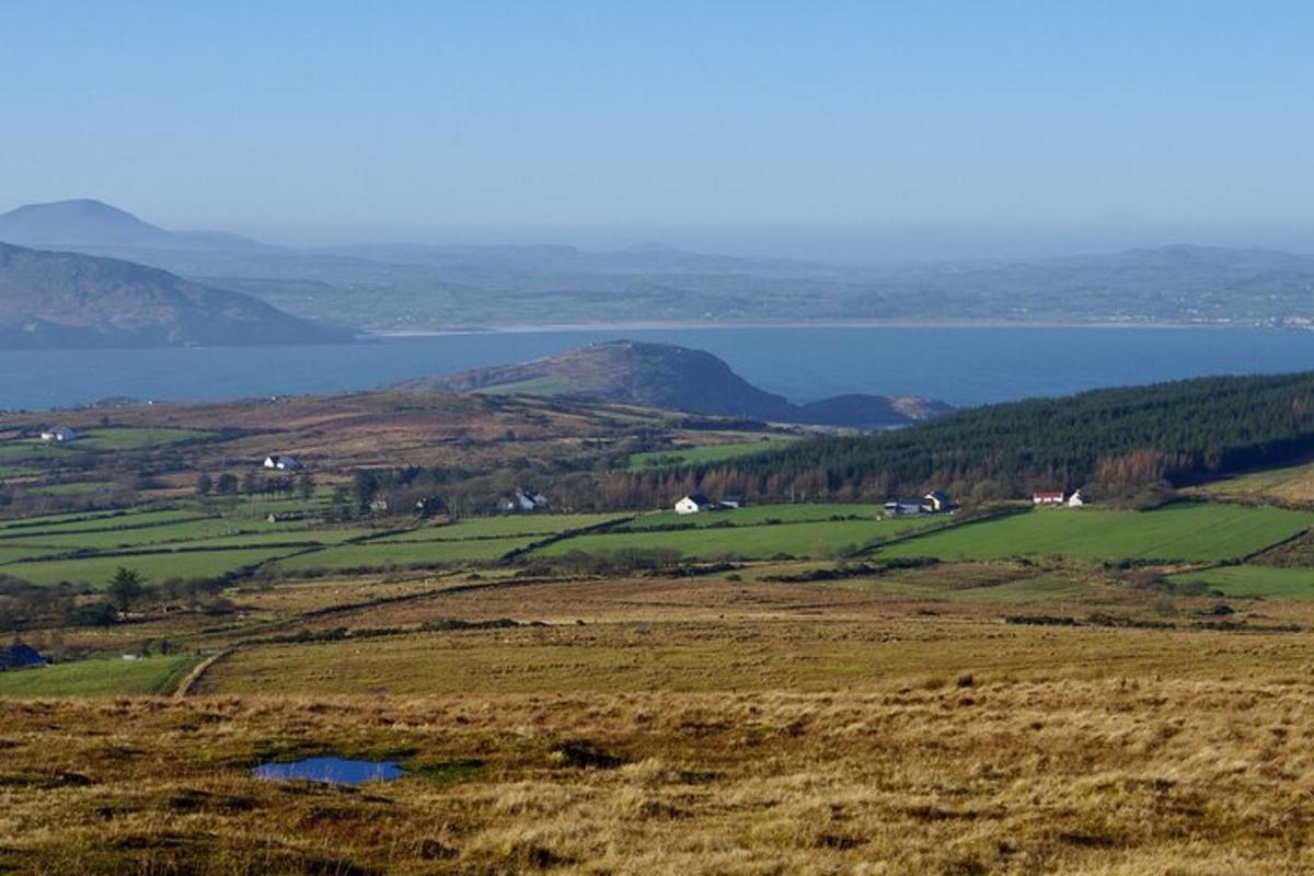 a large field with a view of a large body of water
