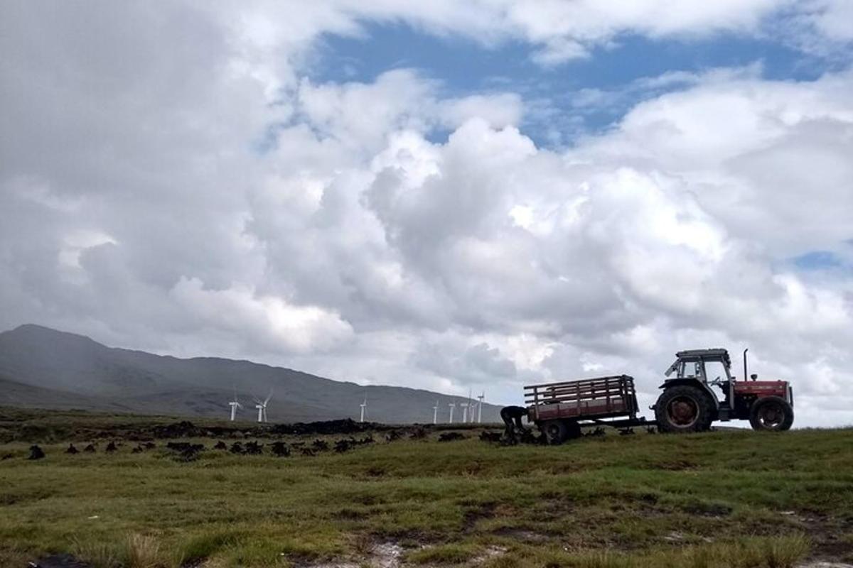 a tractor parked in a field with a bench