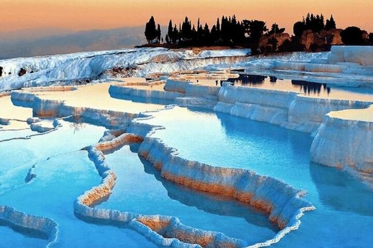 a blue pool of water with snow on the ground