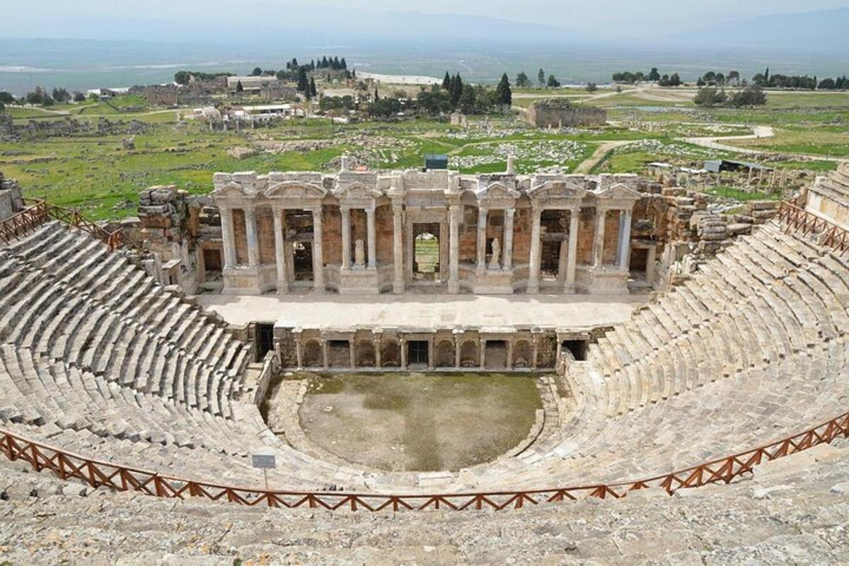 an ancient amphitheater with a view of a city