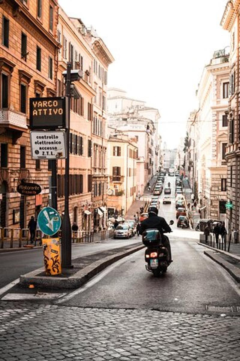 a person riding a motorcycle down a city street