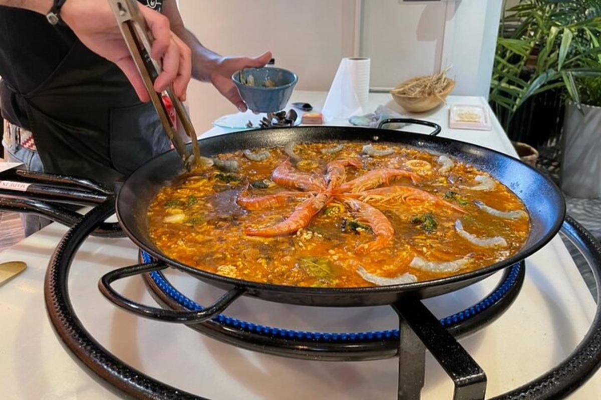 a pan of food on a stove with shrimp in it