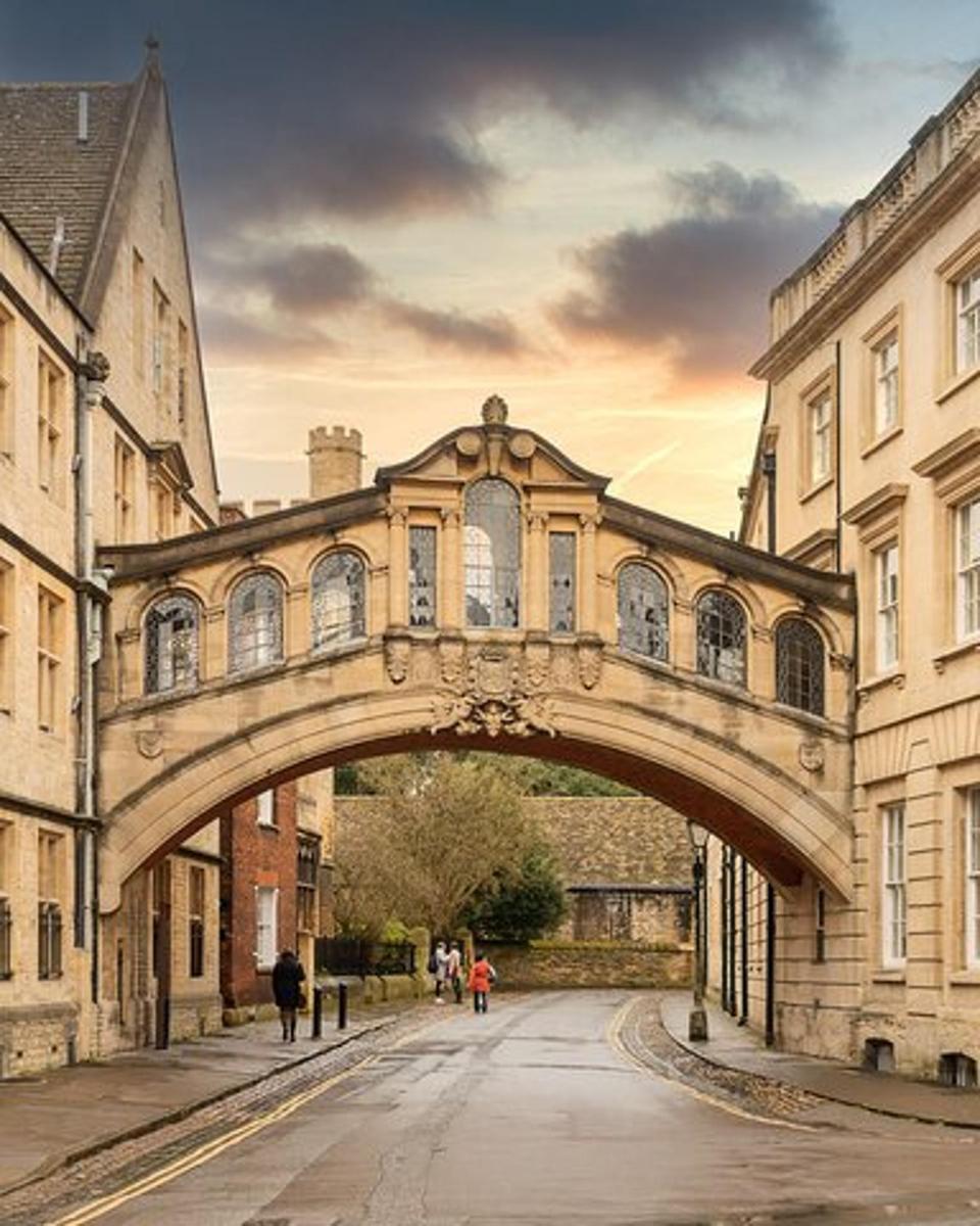 an old bridge over a street in a city