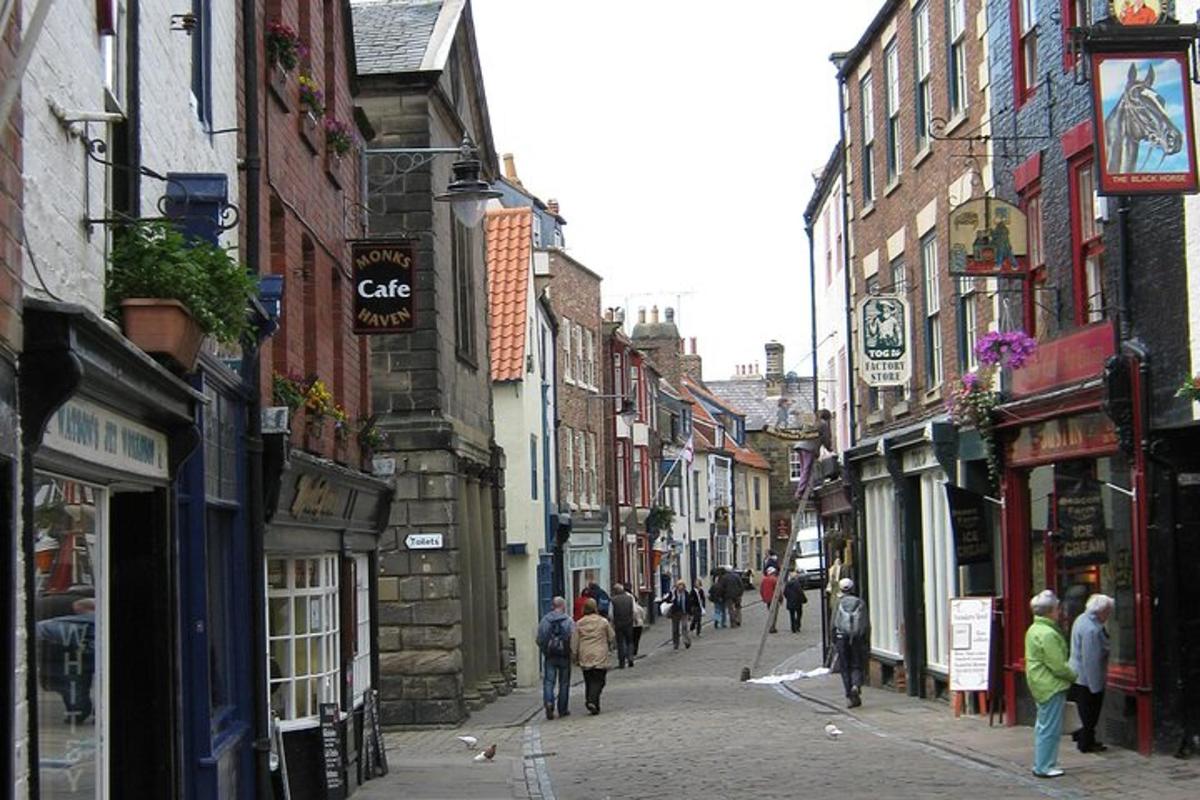 a group of people walking down a street with buildings