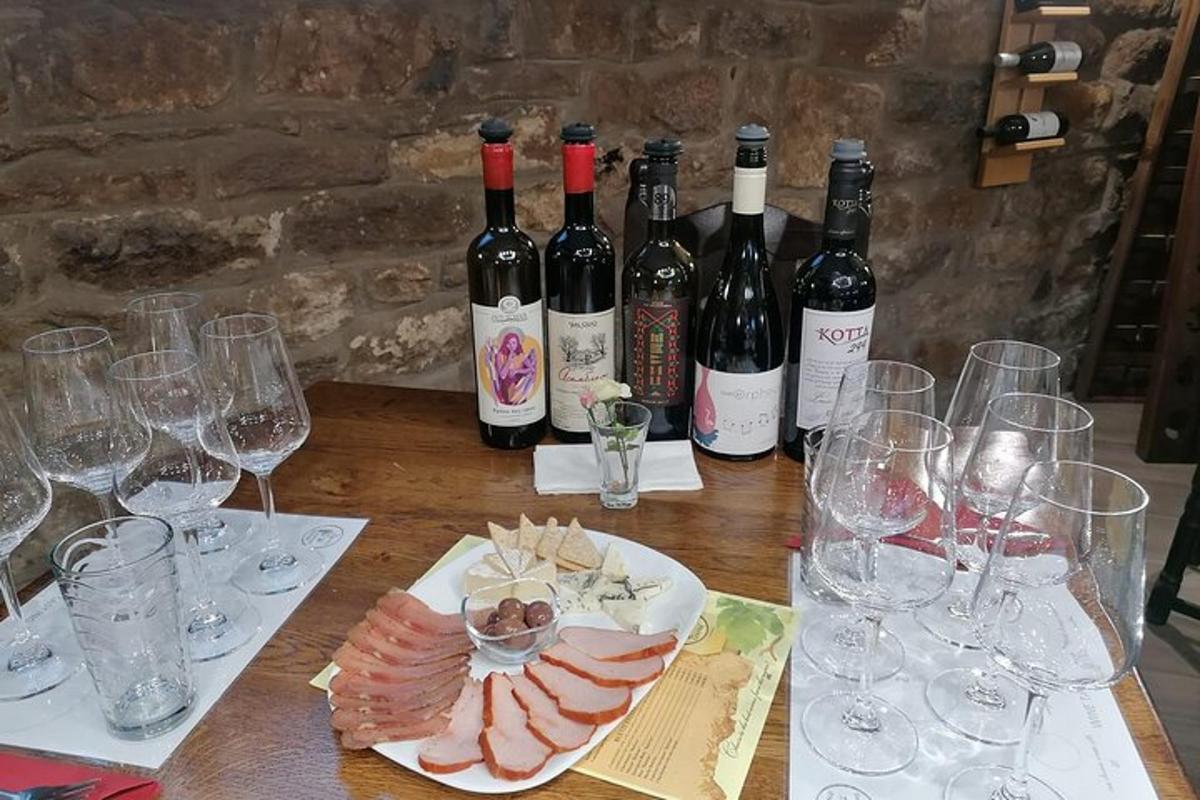 a table with bottles of wine and wine glasses