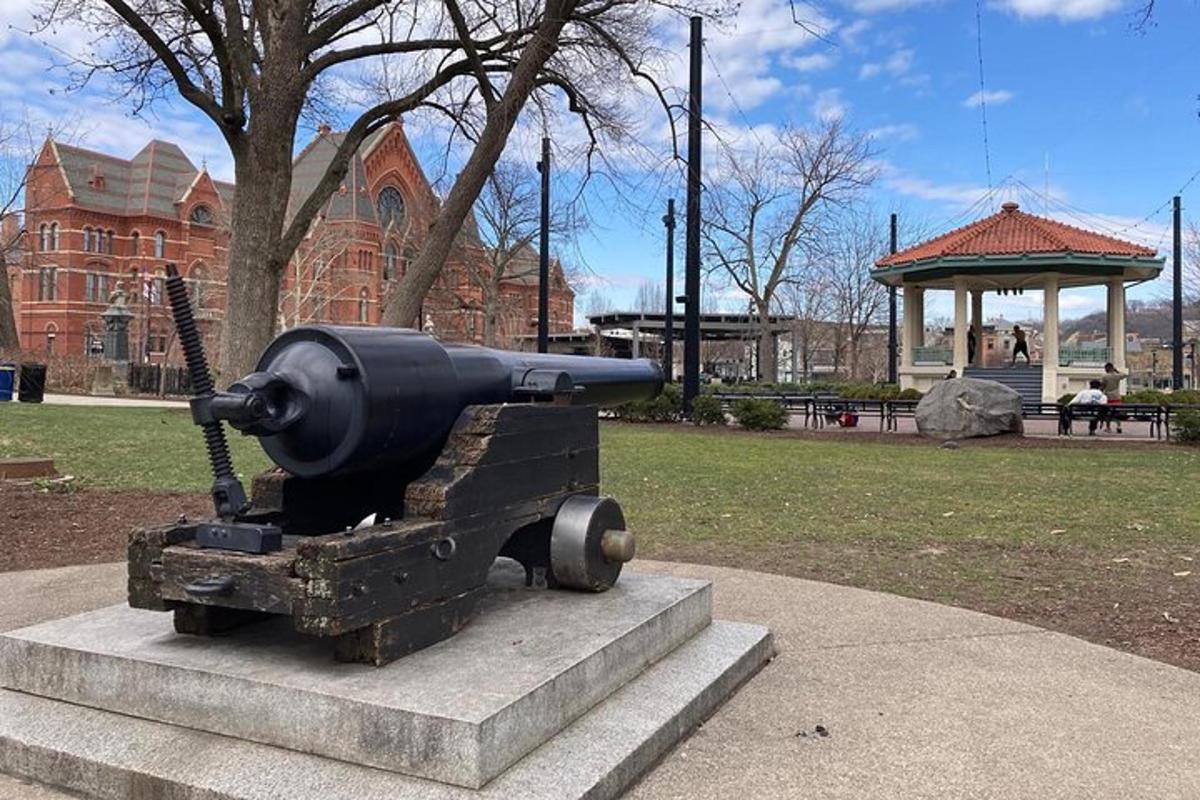 a statue of a gun on display in a park