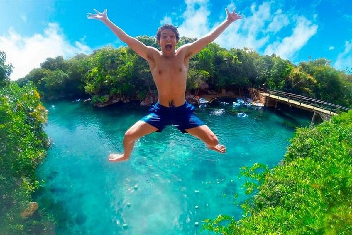 a man jumping in the water in a river