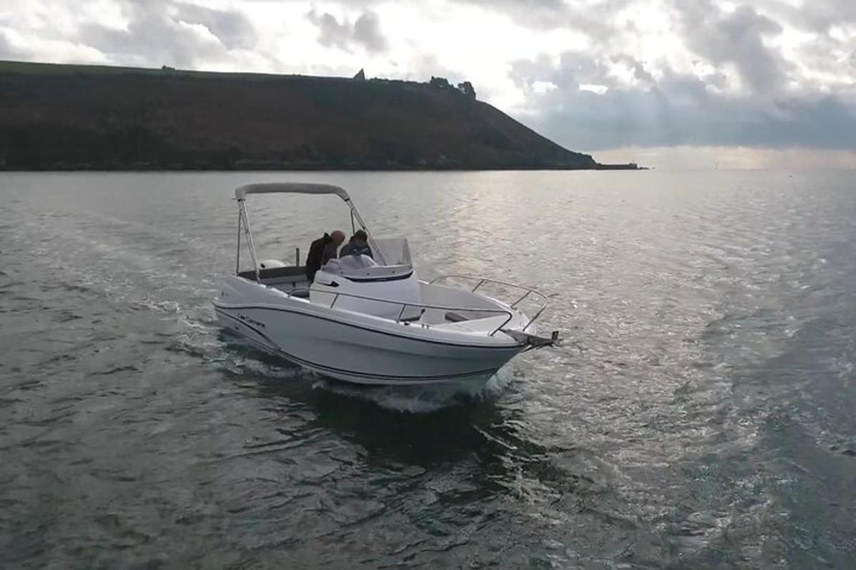 a white boat floating on a body of water