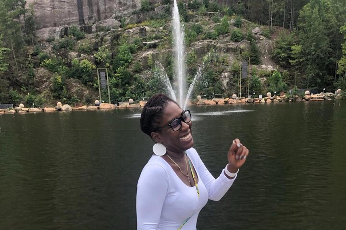 a woman standing in front of a body of water