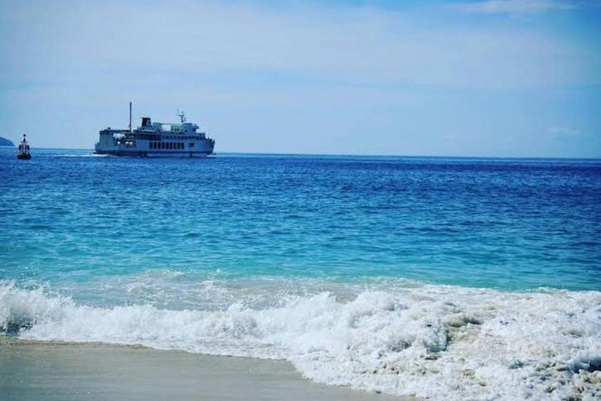 a cruise ship in the ocean with a beach