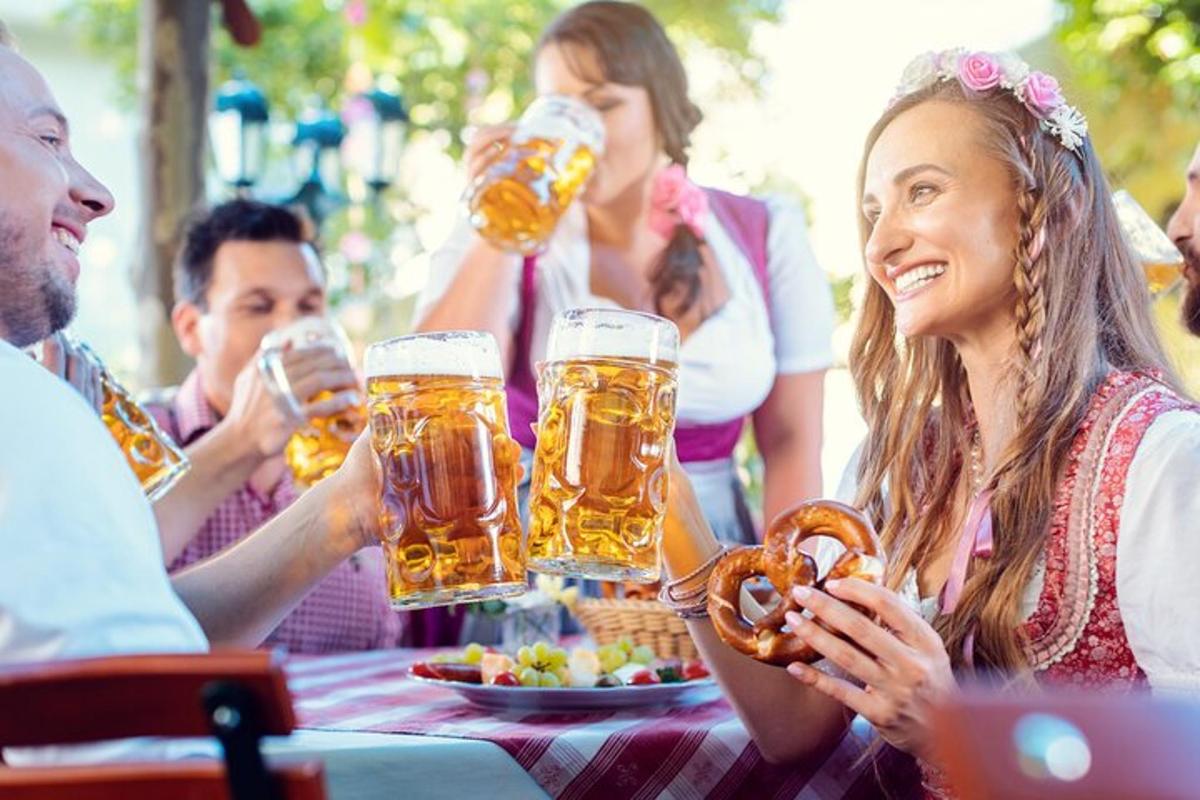 a group of people sitting at a table drinking beer