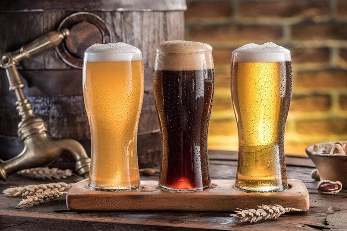 three glasses of beer on a wooden tray