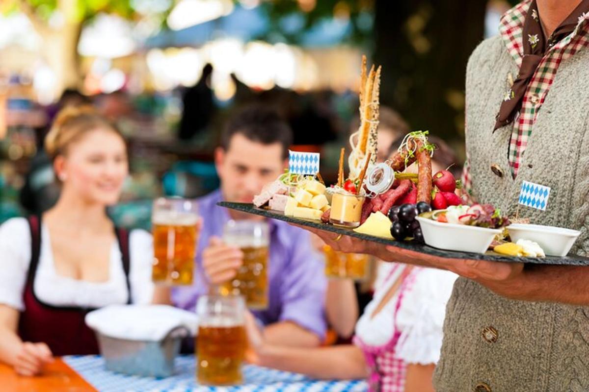 a man is holding a tray of food withbeer