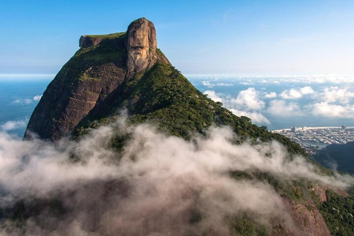 a mountain in the sky with clouds in front of it