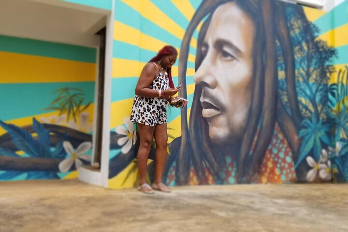a woman standing in front of a wall with a mural