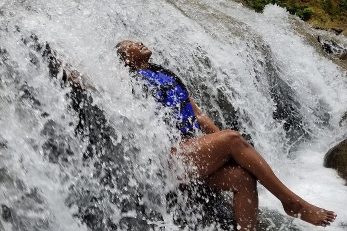 a man is sitting in a waterfall