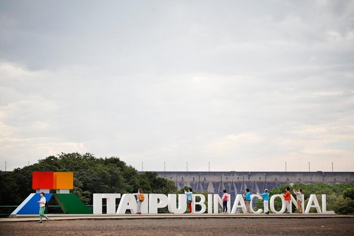 a sign in front of a building with people walking
