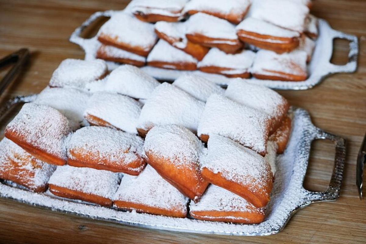 a group of pastries covered in powdered sugar on a table