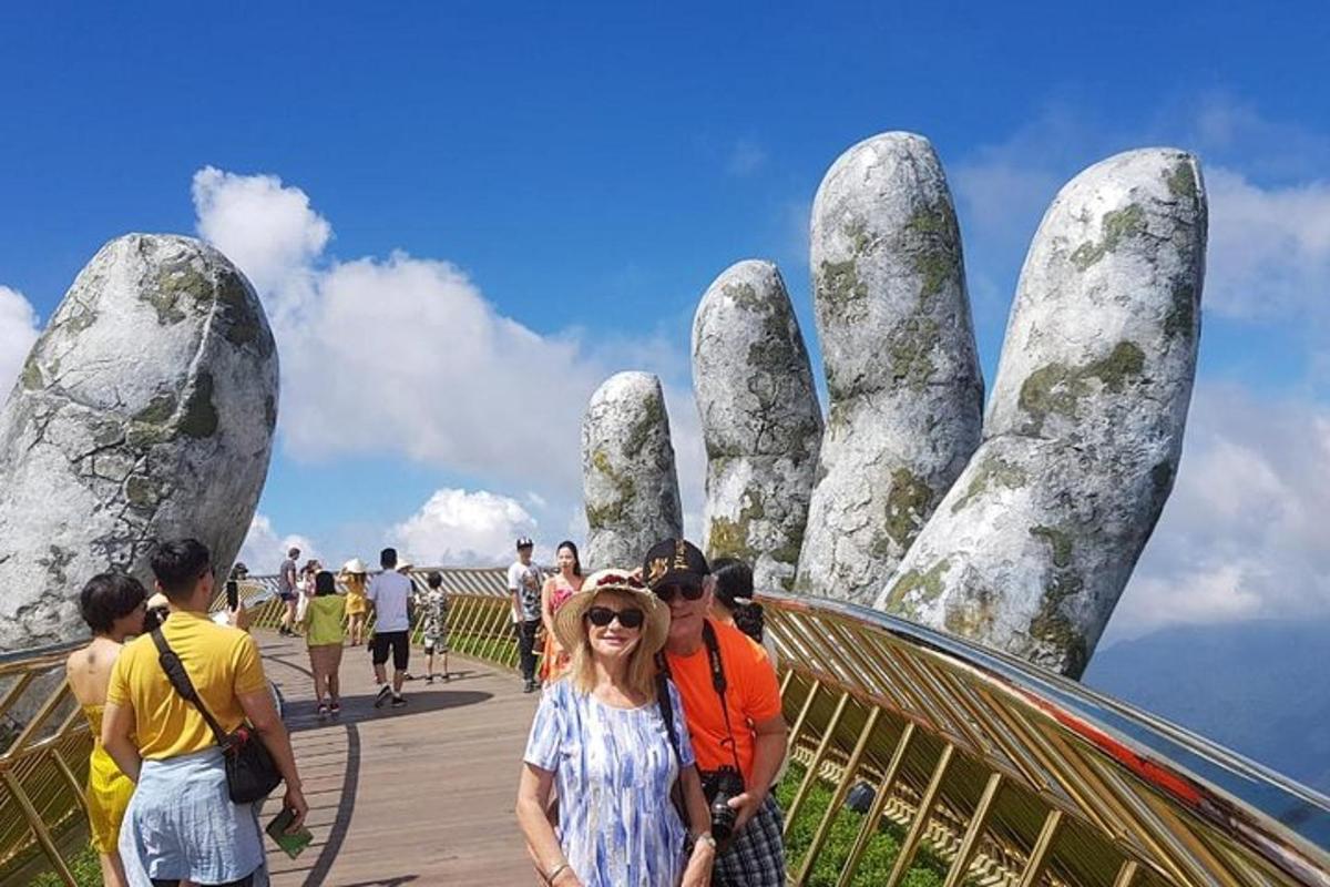 a woman standing in front of a statue with a giant hand