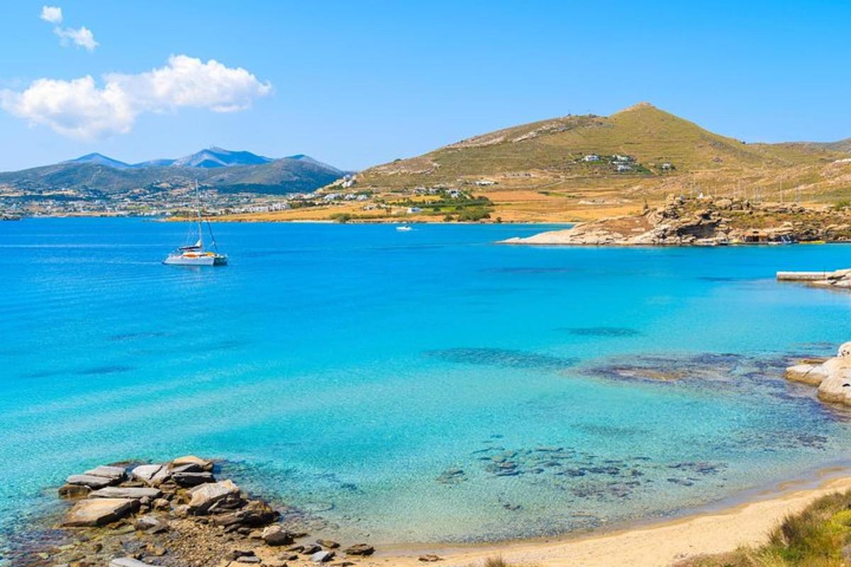 un vaixell en una gran massa d'aigua amb muntanyes