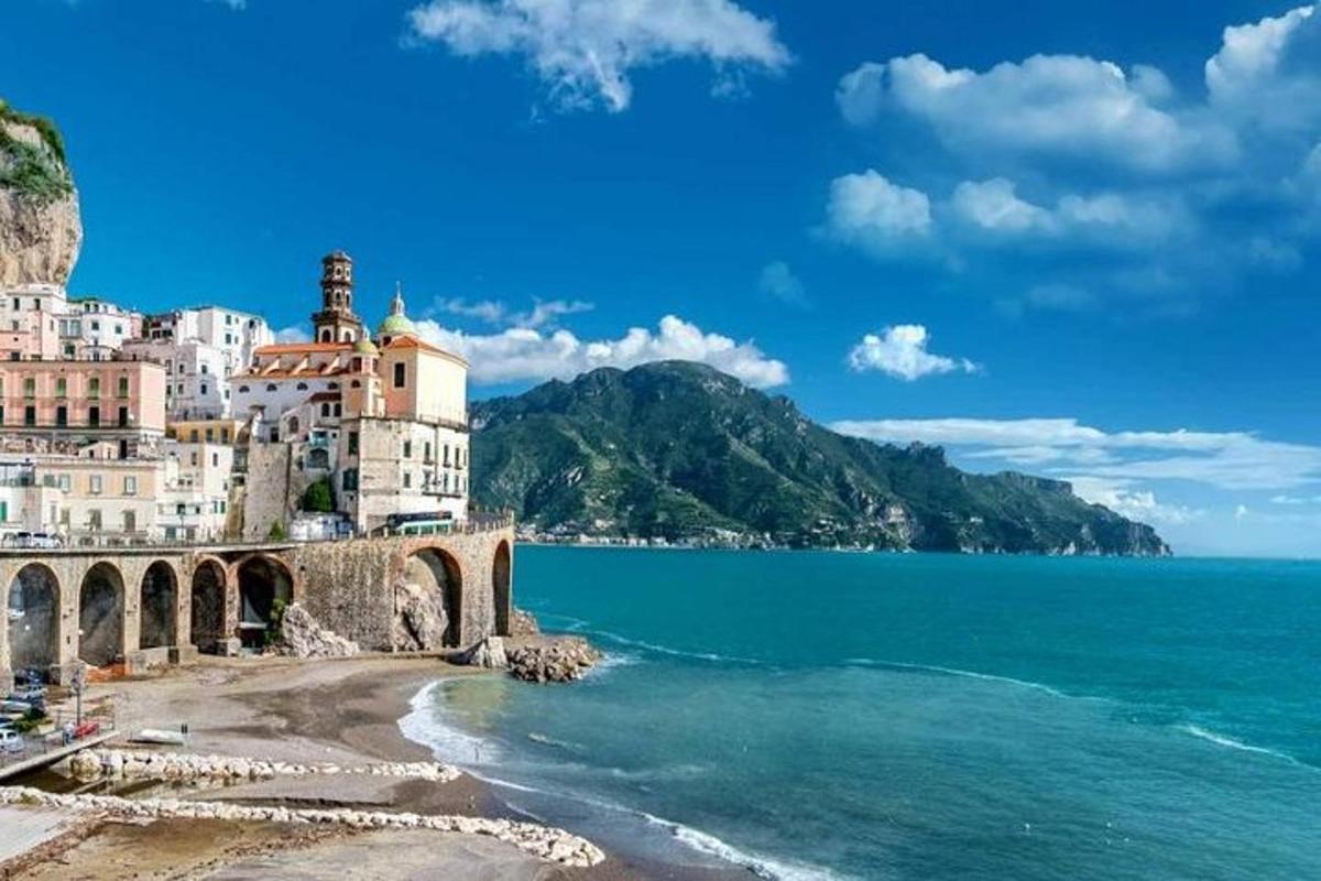 a view of a beach with buildings and the ocean
