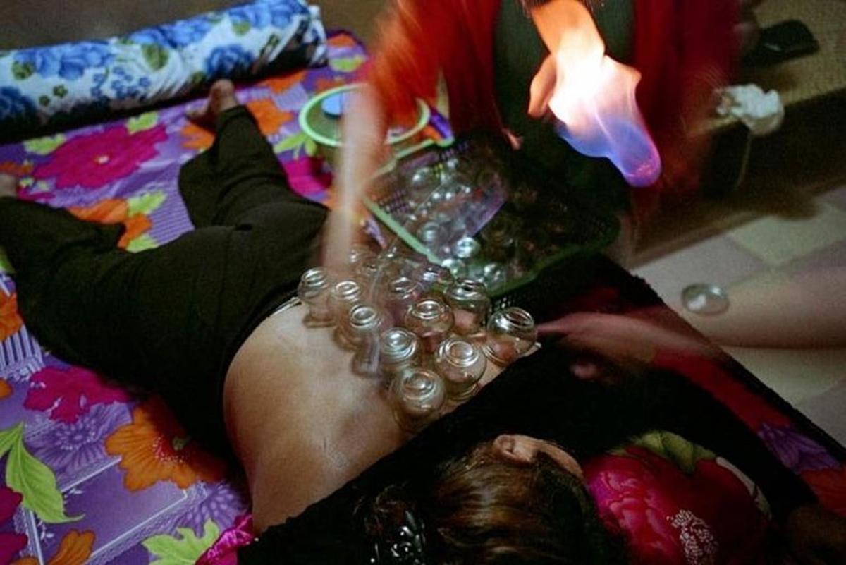 a woman laying on a bed with a dress on