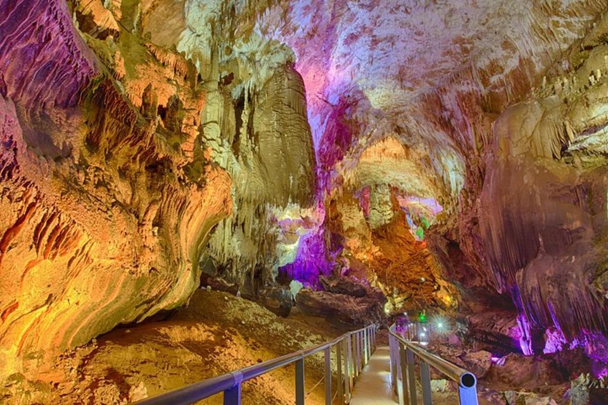 a tour of a cave with a walkway in it