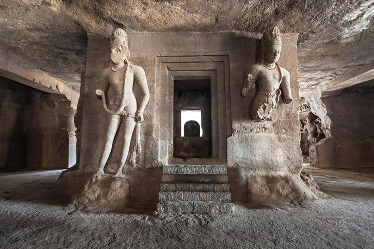 two statues of two people standing in a cave