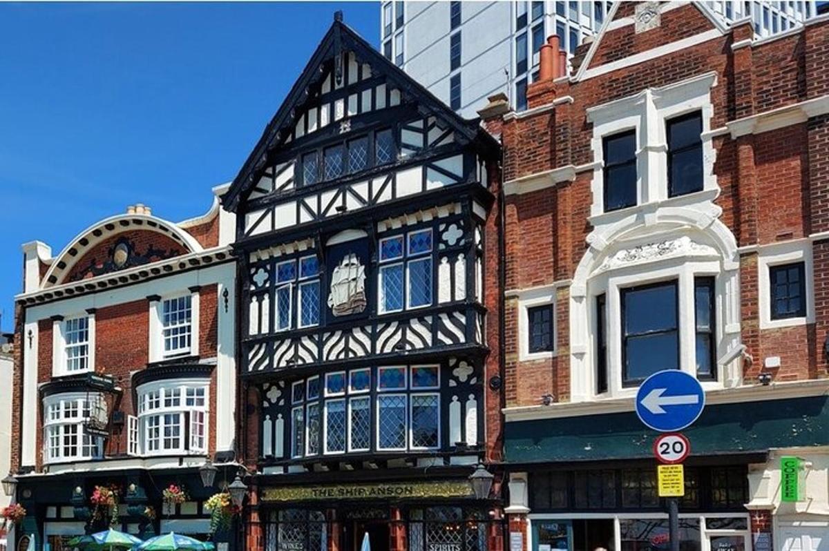 an old black and white building on a city street