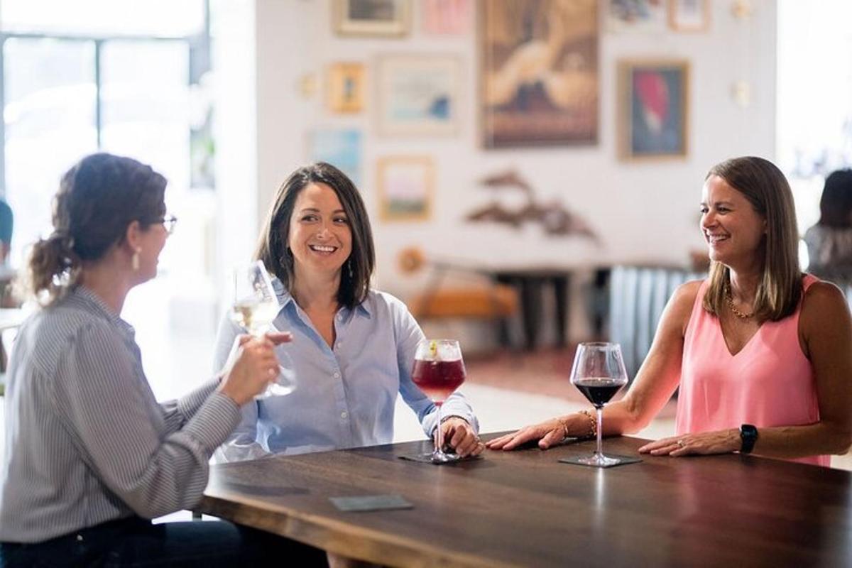 a group of women sitting around a table with wine glasses