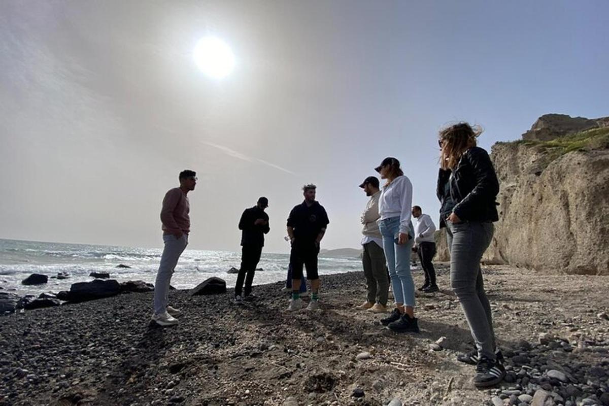 a group of people standing on a rocky beach
