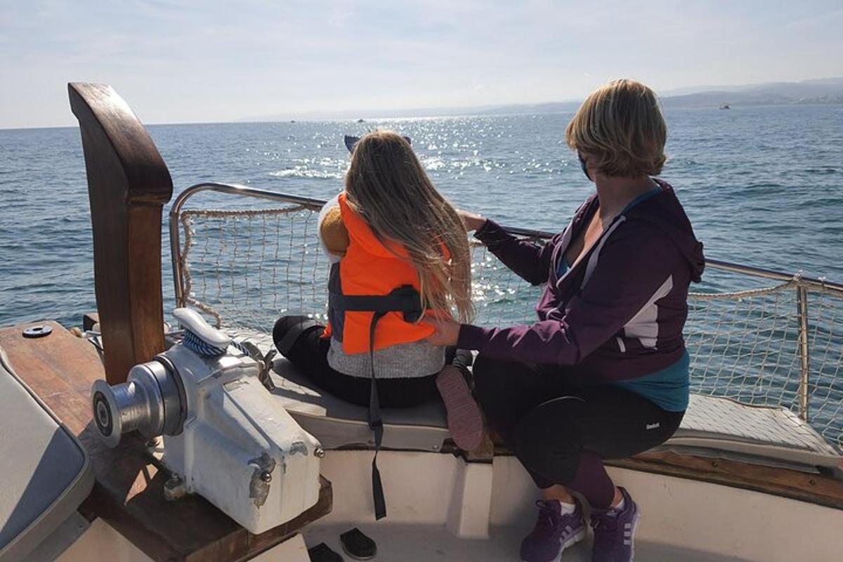 two women sitting on a boat in the water
