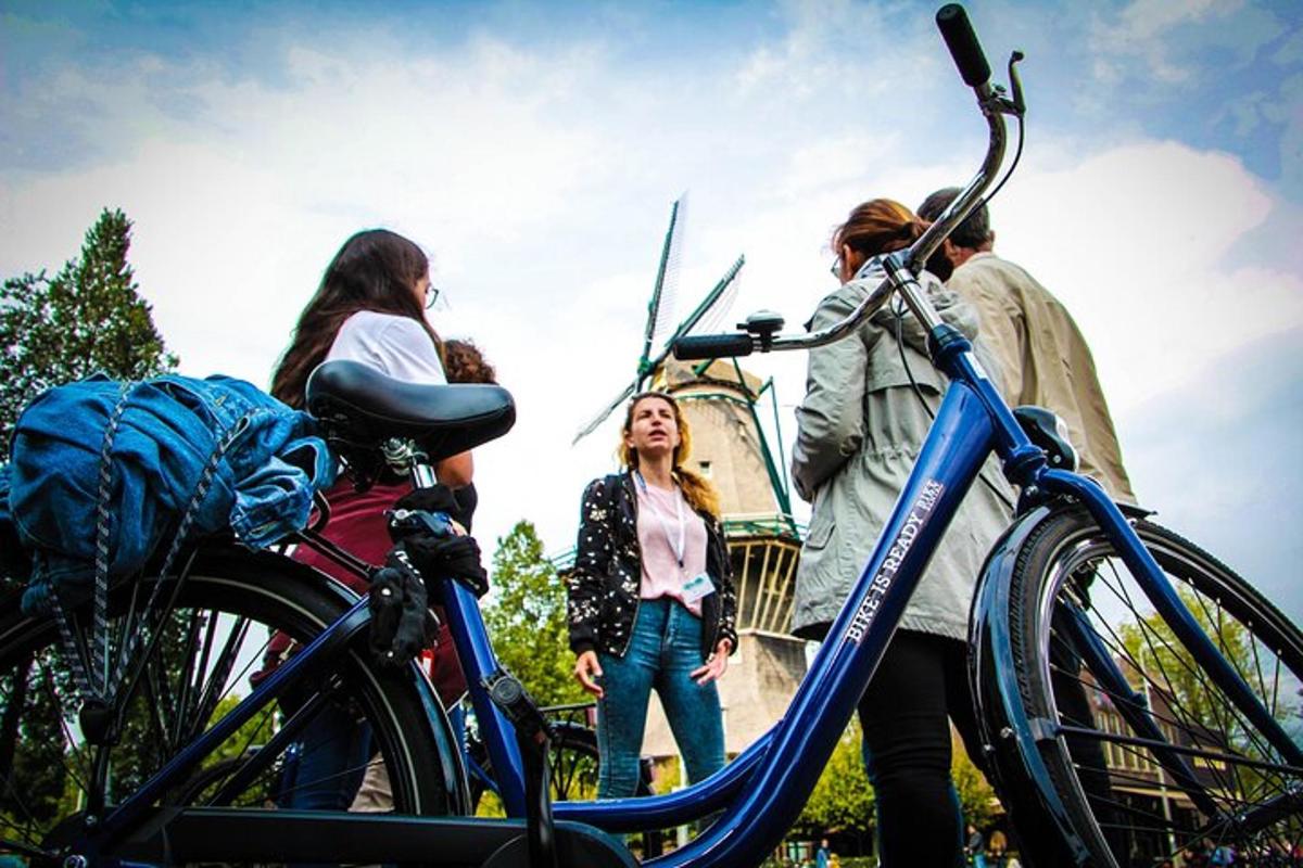 a group of people standing next to a bike