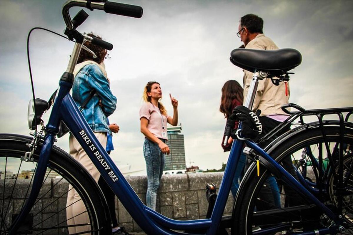 a group of people standing around a blue bike