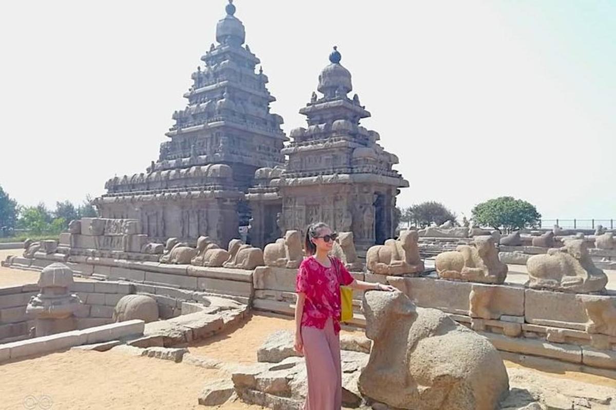a woman standing in front of a temple