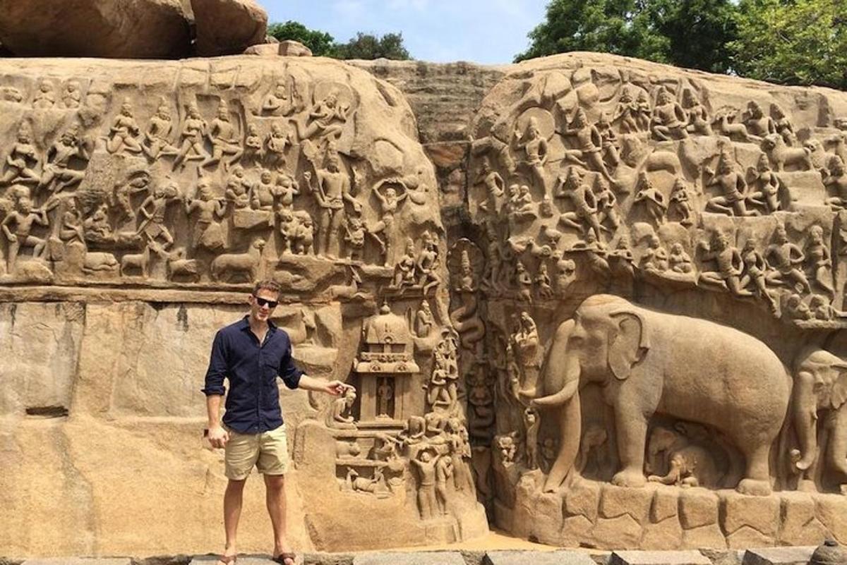 a man standing in front of a statue of an elephant