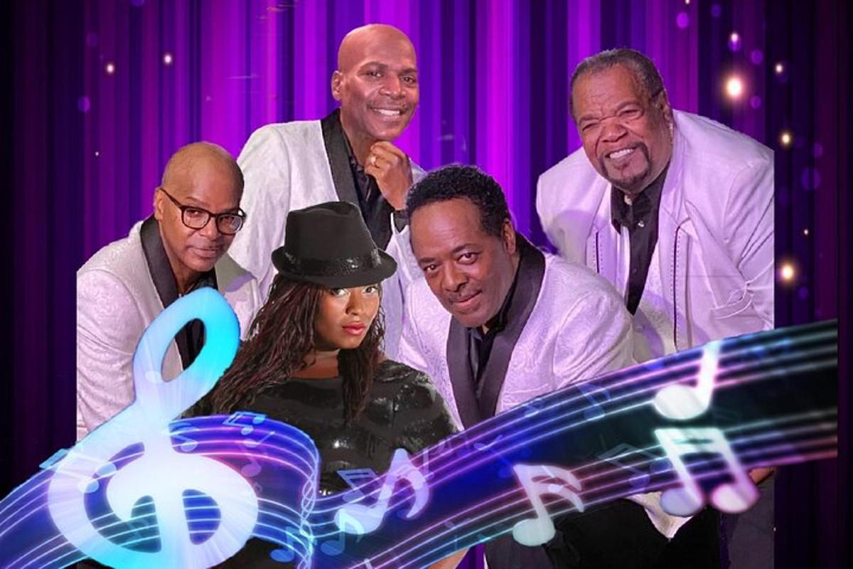 a group of people standing in front of a stage