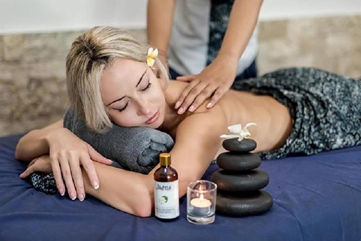 a woman laying on a bed getting a massage