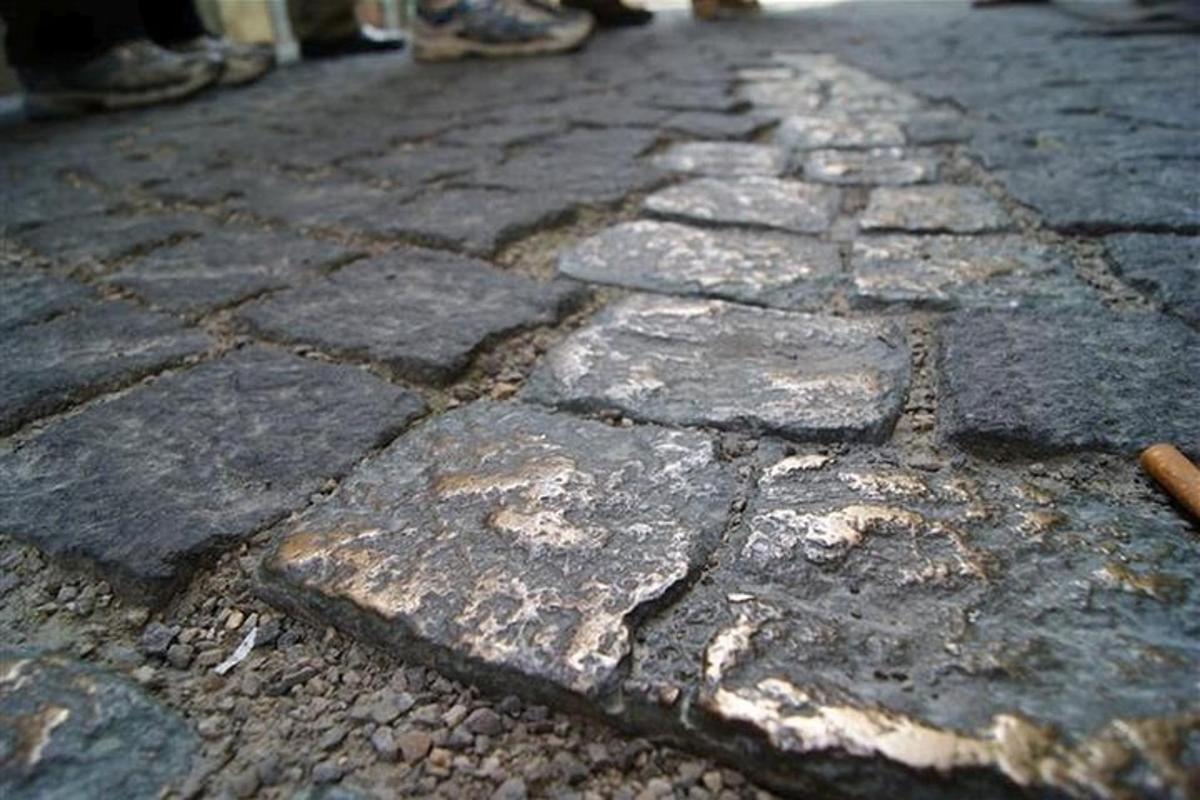 an old cobblestone street with people walking on it