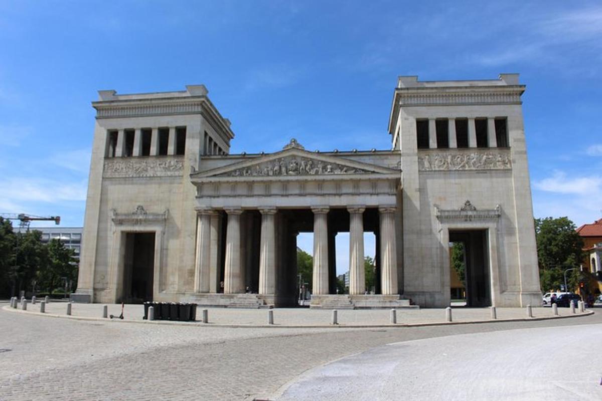 a large stone building with pillars on a street